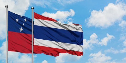 Samoa and Thailand flag waving in the wind against white cloudy blue sky together. Diplomacy concept, international relations.