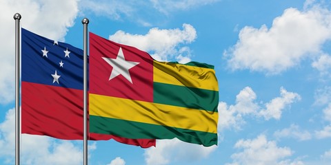 Samoa and Togo flag waving in the wind against white cloudy blue sky together. Diplomacy concept, international relations.
