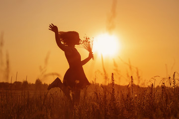 beautiful teenager girl in summer field with cornflower.