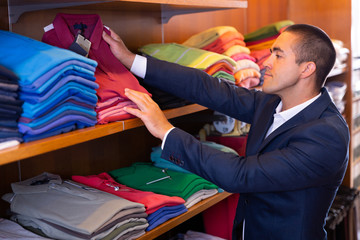 Man choosing polo shirt