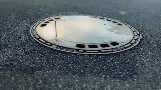 Manhole, inspection chamber hatch. Asphalt.