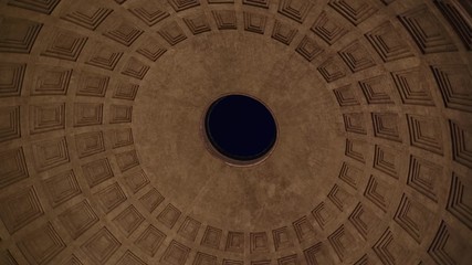 Inside Roman Pantheon at night, look up view with round motion, ancient concrete dome with hole in center in Rome, Italy - Powered by Adobe
