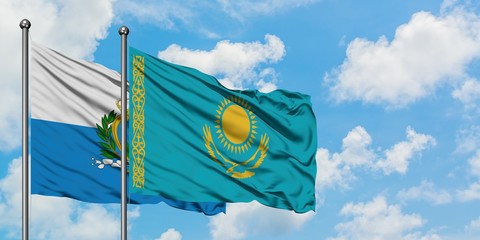 San Marino and Kazakhstan flag waving in the wind against white cloudy blue sky together. Diplomacy...