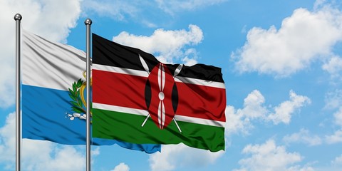 San Marino and Kenya flag waving in the wind against white cloudy blue sky together. Diplomacy concept, international relations.
