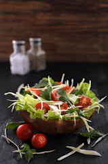 fresh vegetable salad on a wooden table in an eco-friendly dish, vegetarian organic food