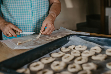 Fototapeta na wymiar closeup of senior woman hands preparing candy or cakes