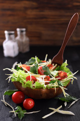 fresh vegetable salad on a wooden table in an eco-friendly dish, vegetarian organic food