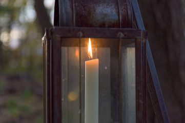 Old-fashioned candle lit lantern during early evening hours