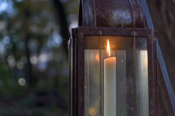 Old-fashioned candle lit lantern during early evening hours