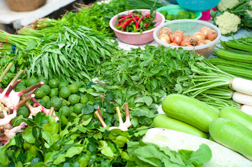 Closeup various types of fresh vegetables display in outdoor shop at morning flea market.