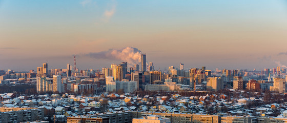 Fototapeta na wymiar Dawn clouds over the metropolis of early winter sunset