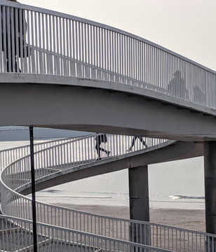 people walking down stairs on a beach, devon england