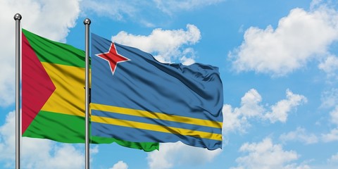 Sao Tome And Principe and Aruba flag waving in the wind against white cloudy blue sky together. Diplomacy concept, international relations.