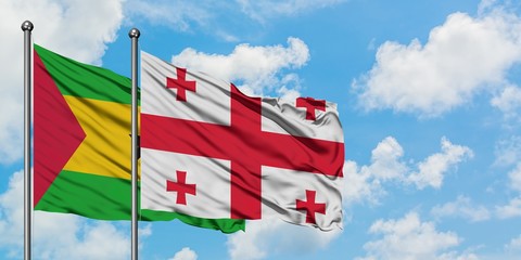 Sao Tome And Principe and Georgia flag waving in the wind against white cloudy blue sky together. Diplomacy concept, international relations.