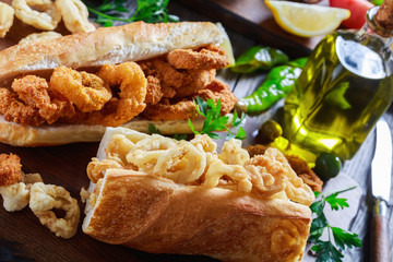 squid sandwiches served on a wooden board
