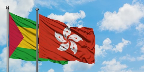 Sao Tome And Principe and Hong Kong flag waving in the wind against white cloudy blue sky together. Diplomacy concept, international relations.