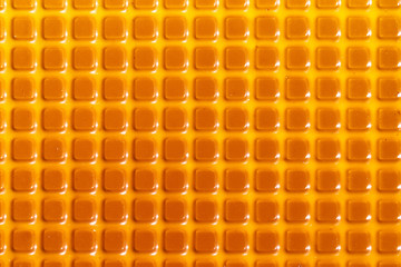 Fototapeta premium Texture with square yellow elements. Plastic candy lining