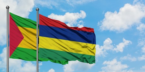 Sao Tome And Principe and Mauritius flag waving in the wind against white cloudy blue sky together. Diplomacy concept, international relations.