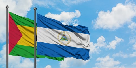 Sao Tome And Principe and Nicaragua flag waving in the wind against white cloudy blue sky together. Diplomacy concept, international relations.