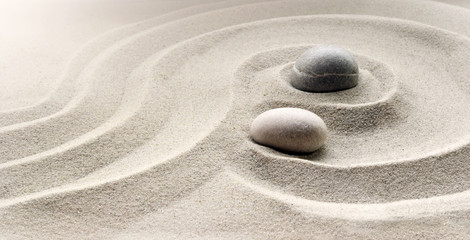 zen garden meditation stone background with stones and lines in sand for relaxation balance and...