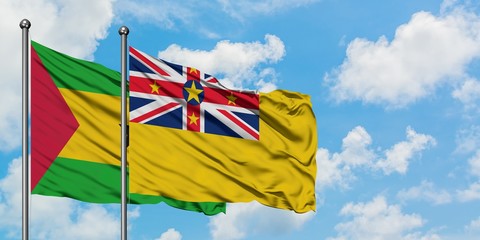 Sao Tome And Principe and Niue flag waving in the wind against white cloudy blue sky together. Diplomacy concept, international relations.