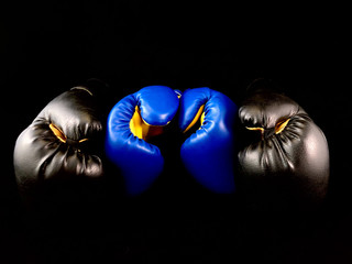 Boxing gloves on a black background. Sports accessories for boxing. Leather gloves for martial...