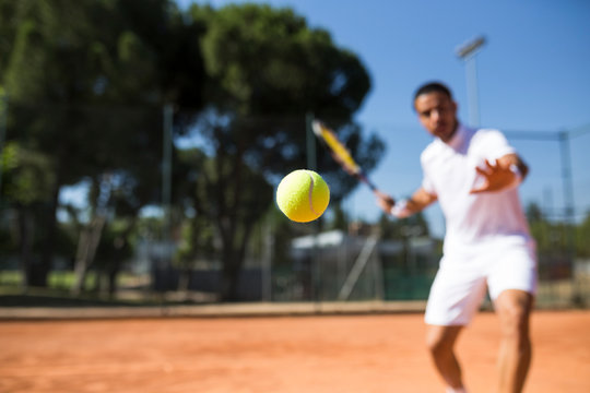 Tennis player during a tennis match, focus on tennis ball
