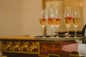 Waiter serving champagne on a tray