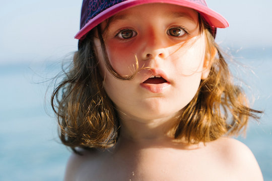 Portrait of little girl wearing cap on the beach
