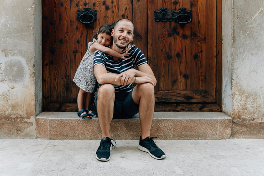 Portrait of happy little girl embracing her father outdoors, Mallorca, Spain