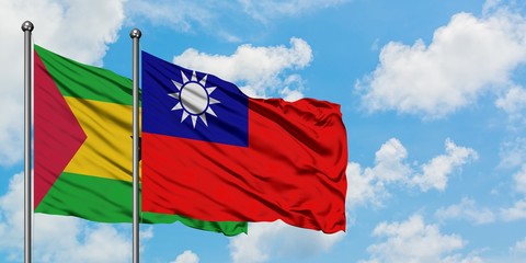 Sao Tome And Principe and Taiwan flag waving in the wind against white cloudy blue sky together. Diplomacy concept, international relations.