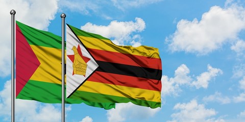 Sao Tome And Principe and Zimbabwe flag waving in the wind against white cloudy blue sky together. Diplomacy concept, international relations.