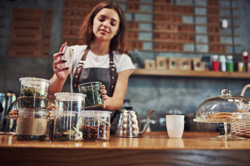 Young female cafe worker indoors. Conception of business and service