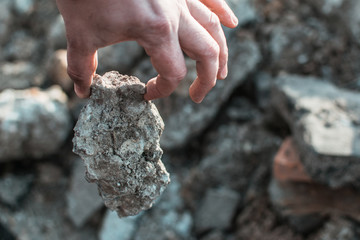 Male hand holding a stone.