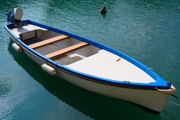 A small boat with external engine on Lake Garda in Italy