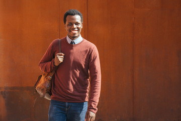 Portrait of a smiling young man, carrying bag