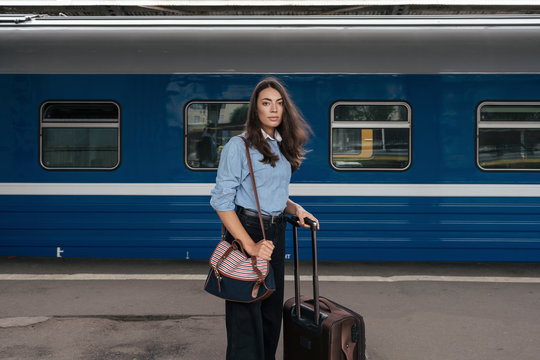 Young female, traveler waiting on train station