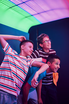 Happy teenage friends in a photo booth