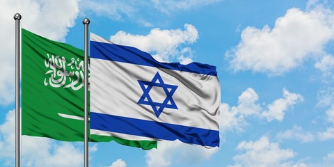 Saudi Arabia and Israel flag waving in the wind against white cloudy blue sky together. Diplomacy concept, international relations.