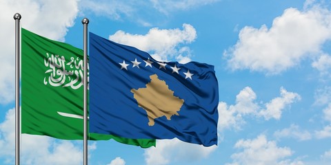 Saudi Arabia and Kosovo flag waving in the wind against white cloudy blue sky together. Diplomacy concept, international relations.