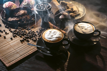 Two cups of cappuccino in hookah lounge. Clay shisha hookah bowl with coffee beans, coffee spices...