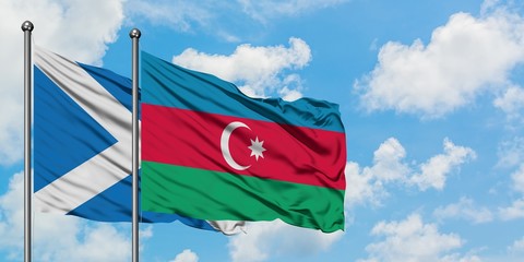 Scotland and Azerbaijan flag waving in the wind against white cloudy blue sky together. Diplomacy concept, international relations.