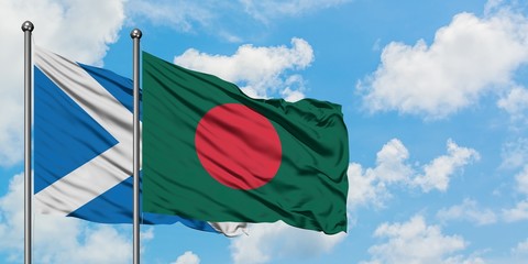 Scotland and Bangladesh flag waving in the wind against white cloudy blue sky together. Diplomacy concept, international relations.