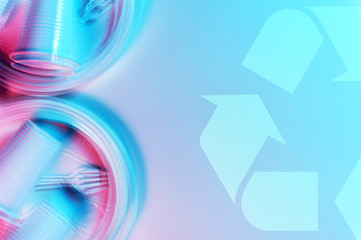 Disposable plastic tableware and recycling sign on a light background in pastel colors. Minimalistic ecologically clean still life. Pop Art. And ecology problem concept.