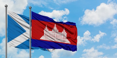 Scotland and Cambodia flag waving in the wind against white cloudy blue sky together. Diplomacy concept, international relations.
