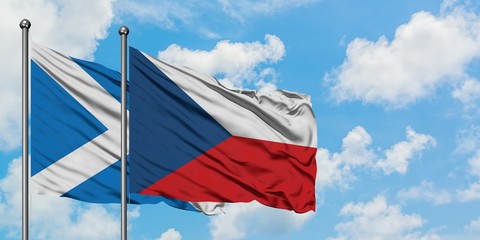 Scotland and Czech Republic flag waving in the wind against white cloudy blue sky together. Diplomacy concept, international relations.