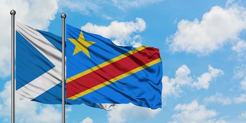 Scotland and Congo flag waving in the wind against white cloudy blue sky together. Diplomacy concept, international relations.