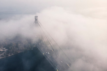 Aerial view of Pivnichny (Moskovsky) bridge in the fog; background with the view of brdige