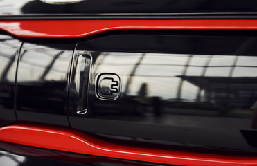 Naklejka premium Particle view of brand new modern electric car. Cropped photo