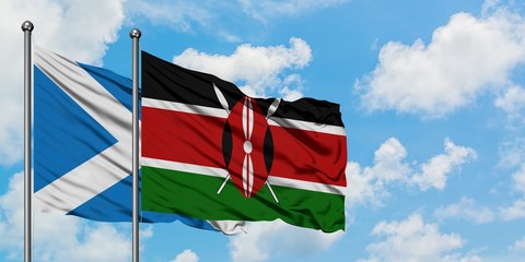 Scotland and Kenya flag waving in the wind against white cloudy blue sky together. Diplomacy concept, international relations.